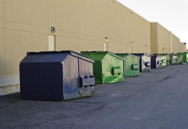 several large trash cans setup for proper construction site cleanup in Brownstown